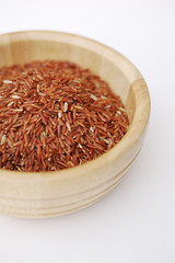 Red rice in wooden bowl
