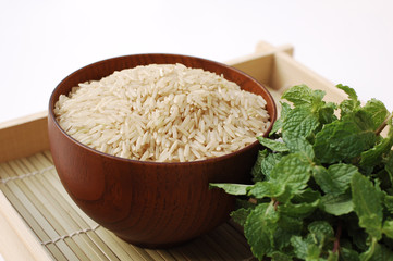 Raw brown rice in wooden bowl