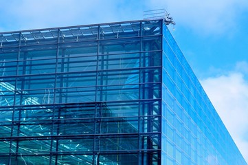 Modern blue glass business center on a clear sky background