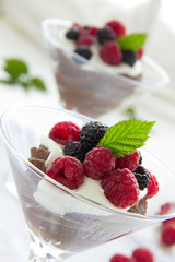 Chocolate mousse with raspberries and cream.