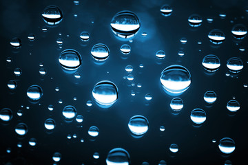 Macro photo of shining water drops on glass