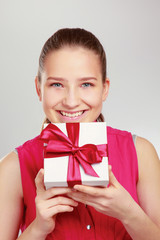 Woman holding gift box isolated on white background