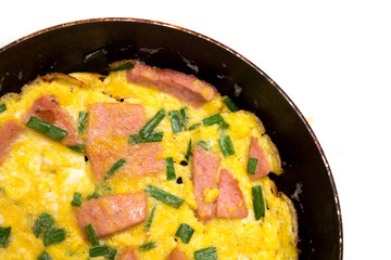 scrambled eggs with sausage in a frying pan 