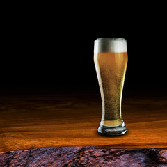 Glass of beer on wood table