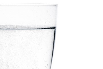 glass with water with bubbles and space for text