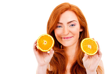 Young red hair woman with oranges in her hands