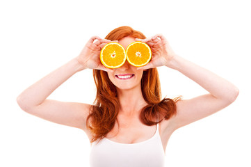 Young cheerful woman with oranges in her hands