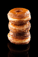Croissant and doughnut mixture pile isolated on black