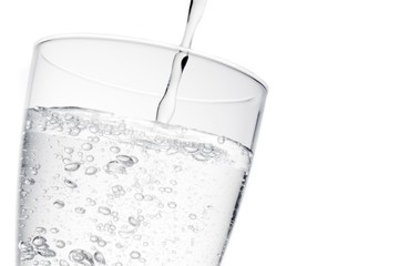 filling a glass with pure water with bubbles and space for text