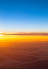 Dramatic sunset.  View of sunset above clouds from airplane wind