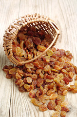 Raisin in a wicker basket and near