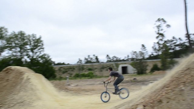 BMX biker jumping dirt jumps