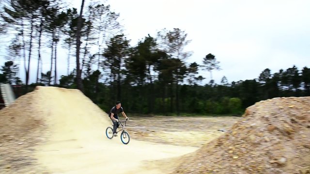 BMX biker jumping dirt jumps