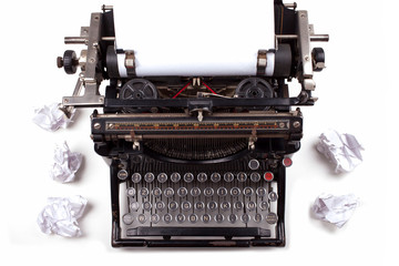 Retro typewriter with paper scattered all around