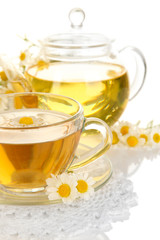 Cup of herbal tea with camomiles close up
