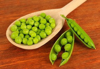 Sweet green peas on wooden background