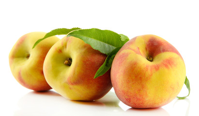 Ripe sweet peaches with leaves, isolated on white