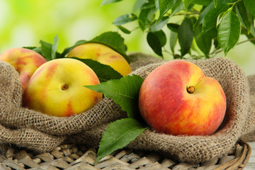 Ripe sweet peaches on wooden table in garden, close up