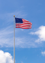 American Flag on Flagpole Waving in Blue Sky