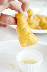 deep-fried doughstick on white plate