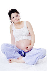 Young pregnant woman sitting on sofa. looking at camera.isolated