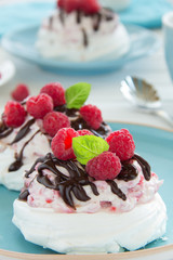 Meringue with raspberry cream, raspberry and chocolate.