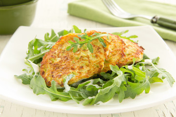 Zucchini fritters with arugula.