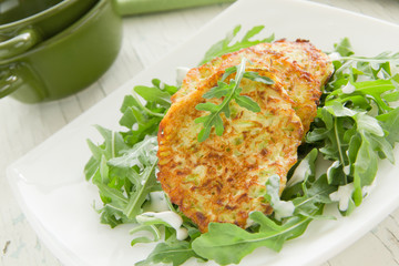 Zucchini fritters with arugula.