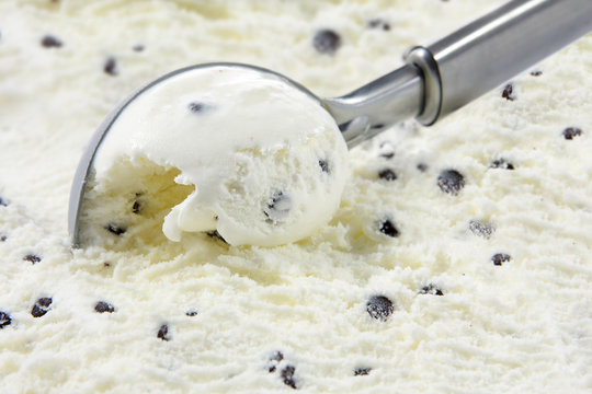 Stracciatella ice cream scooped out of container