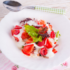 Salad with dressing and fresh raspberry
