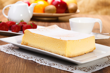 The composition of delicious cheesecake served with strawberries