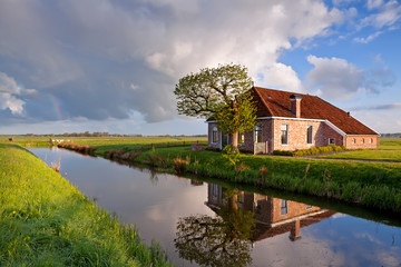 cozy and charming farmhouse by river - obrazy, fototapety, plakaty