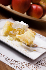 Delicious apple pie with whipped cream (eating cake)