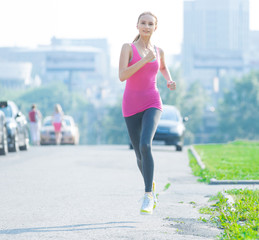 Jogging woman running in city park