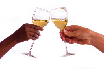 Two people toasting with glasses of white wine