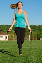 Young woman training with a jumping rope