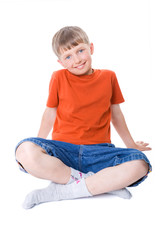 A boy sitting with legs crossed