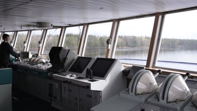 Navigation officer driving the cruise liner on the river.