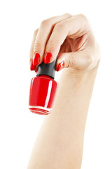 Woman's hand with a bottle of red nail polish