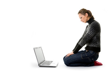 Woman sitting on white background with a laptop