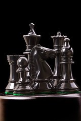Black chess pieces on black © ra3rn