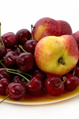 fresh peach and cherry on white background