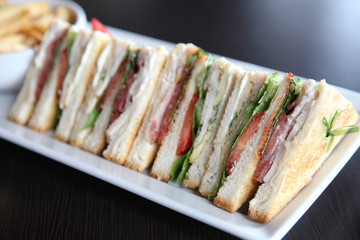 Club sandwich with on wood background
