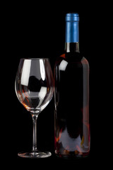 Bottle rose wine and a wineglass isolated on black background