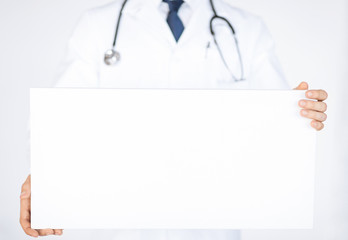 doctor holding blank white banner