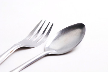 Silver metal fork and spoon on isolated white background