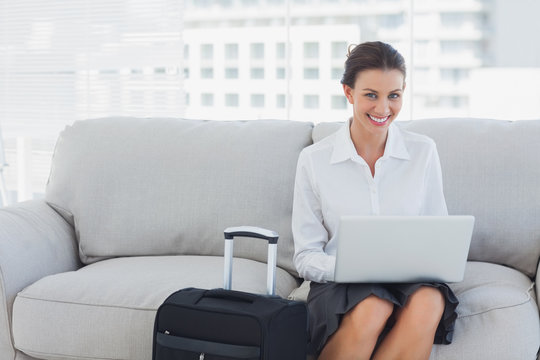 Happy Businesswoman Sitting On The Couch Using Laptop