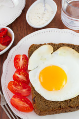 fried egg with tomato on the plate