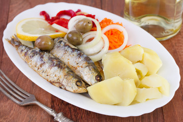 fried sardines with potato and salad