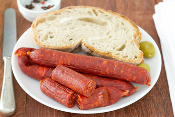 sausages with bread on the white plate